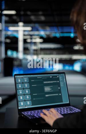 AI assistant, laptop close up and engineer in data center implementing security measures, fortifying cyber threat defense. Artificial intelligence, LLM chatbot on notebook and worker in server hub Stock Photo