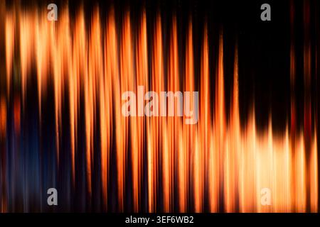 Abstract vertical fiery orange and yellow glowing light streaks background Stock Photo