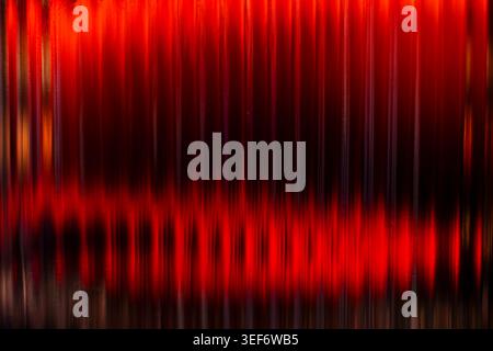 Abstract vertical deep red glowing light streaks on black background Stock Photo