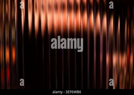 Abstract vertical copper and bronze glowing light streaks background Stock Photo