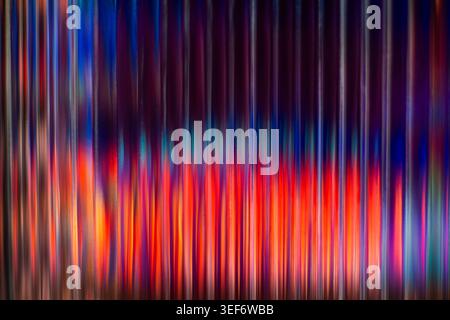 Colorful neon lights distorted through vertical ribbed glass texture Stock Photo