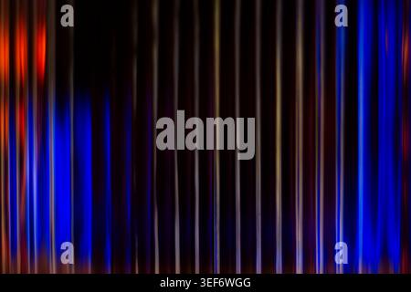 Elegant abstract background featuring deep blue and fiery orange vertical blurred streaks Stock Photo