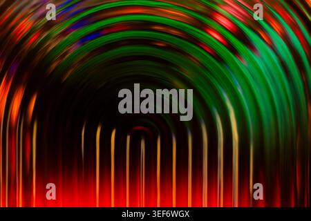 Colorful red and green glowing concentric arch lines on a dark background Stock Photo
