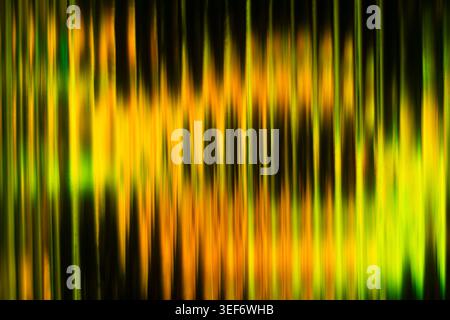 Vibrant yellow and green abstract vertical blurred lines creating a glowing ribbed texture Stock Photo