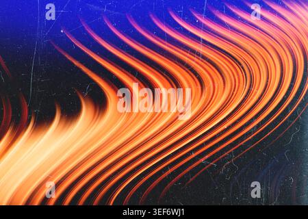 Fiery orange wavy light trails over dark blue background with aged film scratches Stock Photo