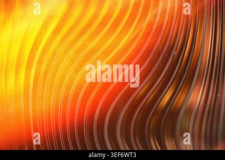 Warm golden yellow curved light streaks on a vintage grainy textured background Stock Photo