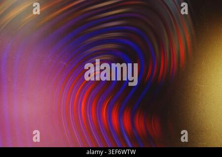 Abstract dark background featuring cosmic glowing purple and red swirling liquid with film dust Stock Photo