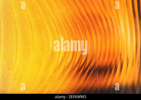 Golden glowing abstract background with sweeping warm curved light lines and grunge texture Stock Photo