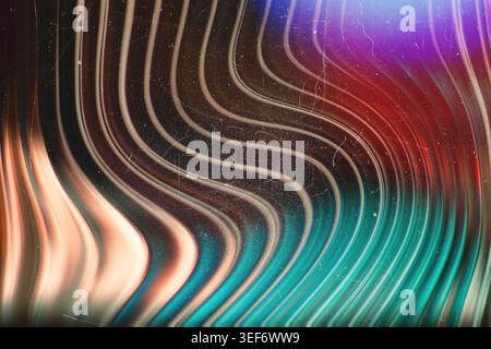 Dark abstract backdrop featuring vertical glowing teal and red wavy lines with grunge texture Stock Photo