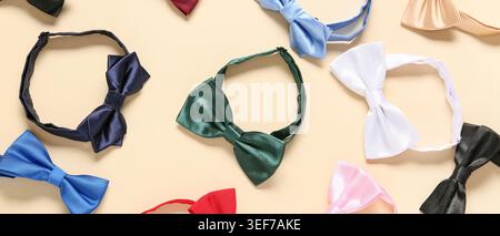 Different stylish bow ties on beige background Stock Photo