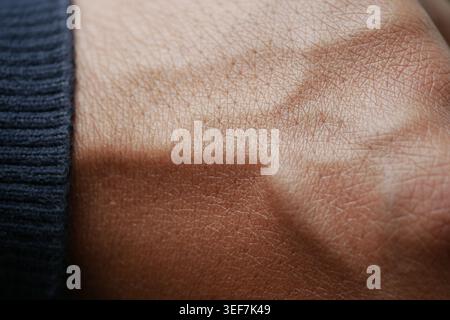 Close-up view of hand with detailed skin texture and shadows Stock Photo