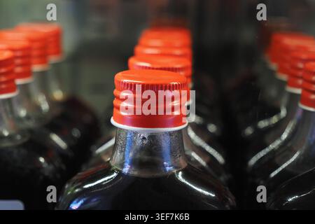 Bottles with red caps are lined up in a store Stock Photo