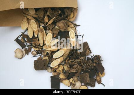 Dried Traditional Chinese Medicine Herbs Spilling from Bag Stock Photo