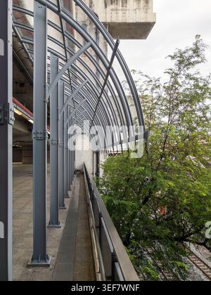 Modern architectural steel roof frames of an outdoor urban walkway at a transit station, featuring repeating geometric lines and industrial design. Stock Photo
