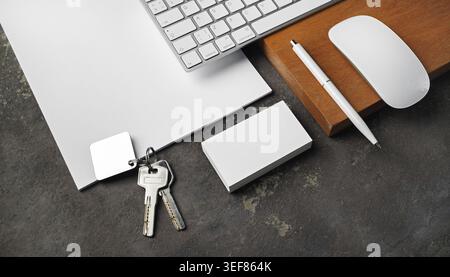 Blank stationery, keys and gadgets. Real estate agency concept Stock Photo