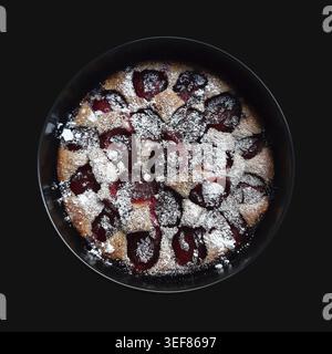 Whole plum pie on black background. Isolated with clipping path Stock Photo
