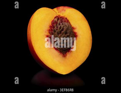 Fresh peach isolated. Organic nectarine or peach slice on black background. Cut out with clipping path Stock Photo