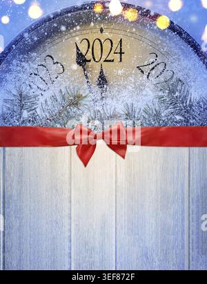 Countdown to midnight. Retro style clock on wooden table is counting last moments before Christmas or New Year 2024. View from above Stock Photo