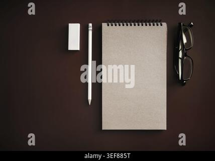Blank kraft sketchbook, glasses, pencil and eraser. Flat lay Stock Photo