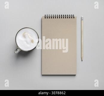 Blank notepad, coffee cup and pencil on paper surface. Flat lay Stock Photo