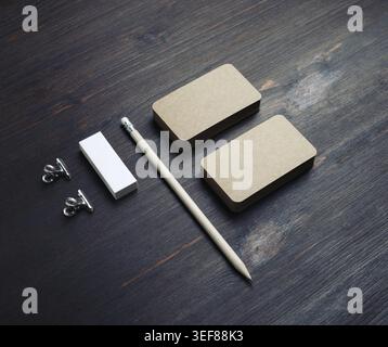 Blank kraft stationery set. Blank vintage business cards, pencil and eraser on wood table background Stock Photo