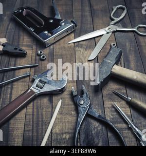Old used work tools on vintage wooden background Stock Photo