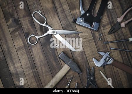 Different old tools on vintage wooden background. Flat lay Stock Photo
