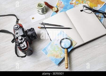 Personal traveler's items. Photo of travel accessories on light wooden background Stock Photo