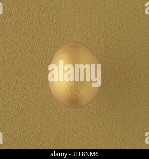 Golden painted egg on yellow background Stock Photo