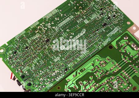 Close-up of printed circuit board with integrated circuits, electronic components inside modem router devices on white background, Studio Composition Stock Photo