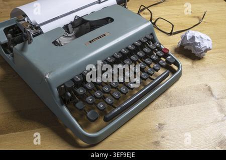 An old typewriter on a wooden table Stock Photo