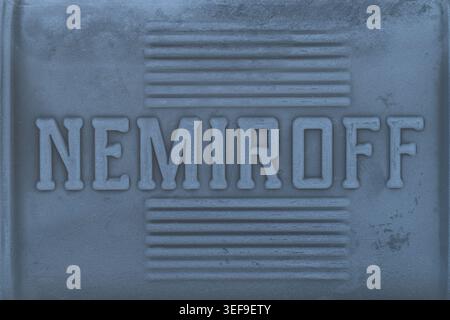 Lviv, Ukraine - May 13, 2026: Close-up of embossed lettering on frozen glass bottle with frost texture and blue monochrome tint Stock Photo
