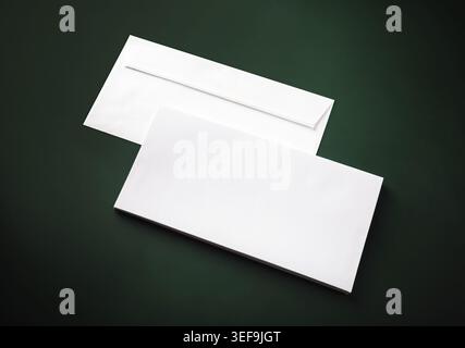 Two blank white envelopes on green background. Copy space Stock Photo