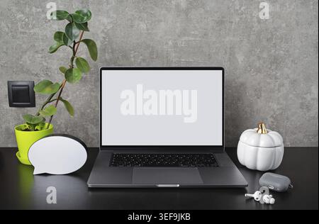 Laptop with blank screen with supplies and gadgets. Responsive design template Stock Photo