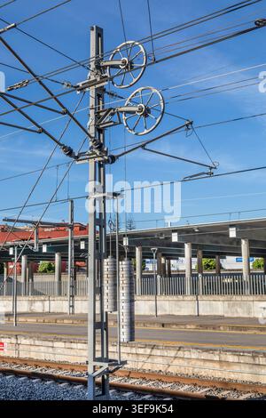 Tension weights for overhead electic railway cables. Stock Photo