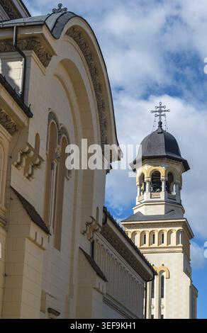 The historic Orthodox Coronation Cathedral features ornate white stone architecture and dark domes under a bright blue sky Stock Photo