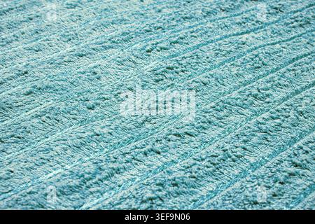 Soft turquoise terry cloth towel texture with elegant ribbed stripes. Close-up of plush blue-green fabric for spa, home, or hygiene background Stock Photo