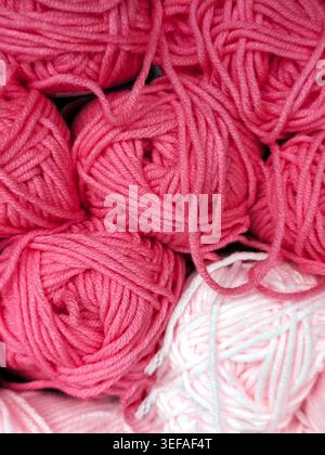 Closeup of multi-colored yarn balls stacked together, soft fiber texture, knitting material, full frame background Stock Photo
