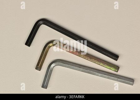 Three assorted allen wrenches flat lay on white background fastening tools. Stock Photo
