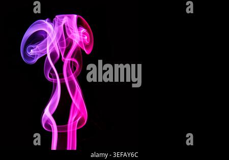 Purple smoke spirals upward in dramatic curls, creating a striking abstract backdrop for science themes or anti-smoking campaigns. Stock Photo