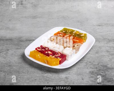 Fruit sweets with nuts on the white plate. Traditional middle eastern sweets. Stock Photo