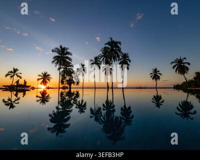 Infinity pool reflections at sunset over the calm waters in Madagascar Stock Photo