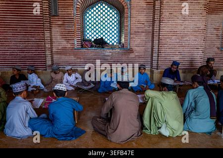 Students participate in their studies in the medressa of Shah Jahan Mosque in Sindh, Pakistan, focused on learning and education Stock Photo