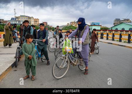 Boys riding bicycles in Ghazni, Afghanistan, showing daily life and community activities Stock Photo