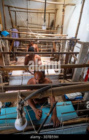 Man spins loom in local factory in Bangladesh during busy work hours Stock Photo