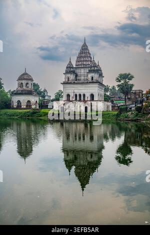 Puthia Rajbari Complex with reflections on water in Bangladesh during the evening Stock Photo