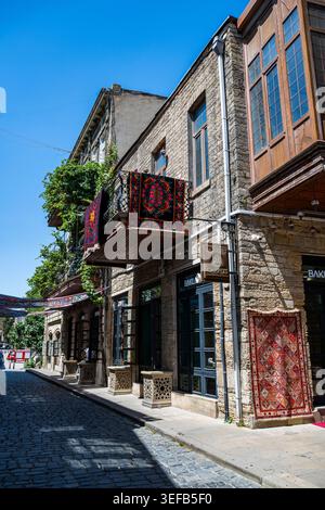 Exploring old streets with traditional buildings and carpets in Baku, a historic city in Azerbaijan Stock Photo