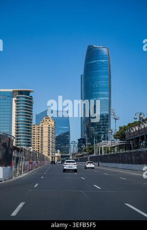 High rise buildings and road in Baku, Azerbaijan with cars driving under a clear sky Stock Photo