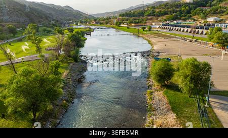Aerial view of a river flowing through a lush tropical landscape with ...
