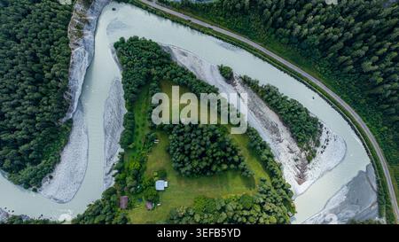 Aerial view of a winding river bend surrounded by lush green ...